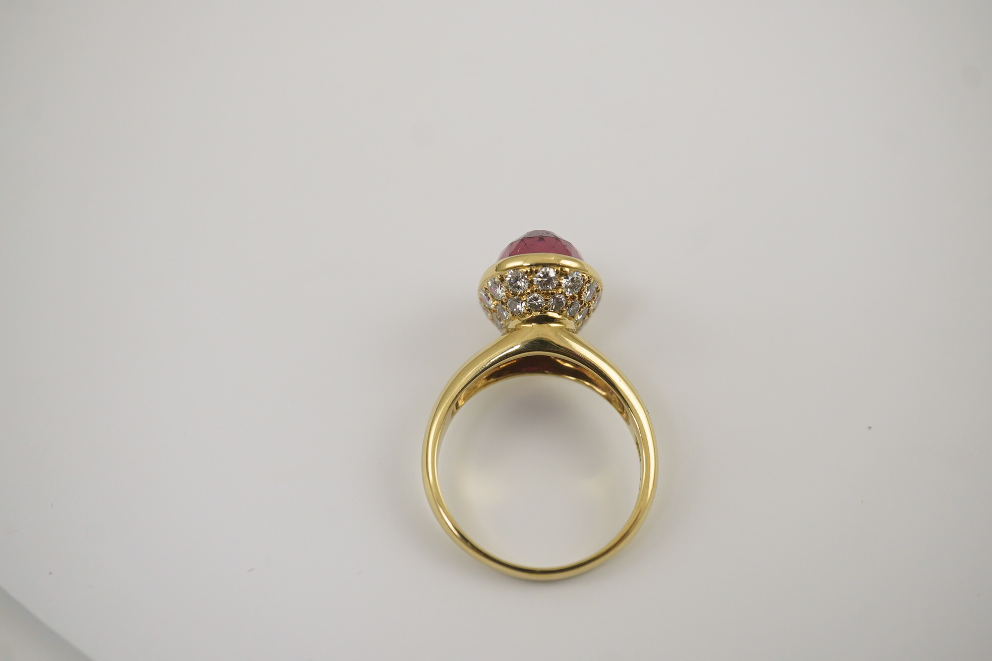 A modern 18k gold and single stone fancy oval cut deep pink tourmaline set dress ring, signed Asprey?